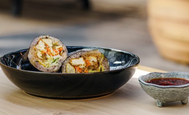 tofu sushi roll in bowl with sauce